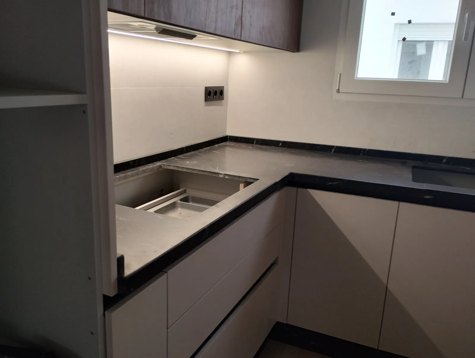 LED strip under kitchen wall cabinets, lighting the worktop