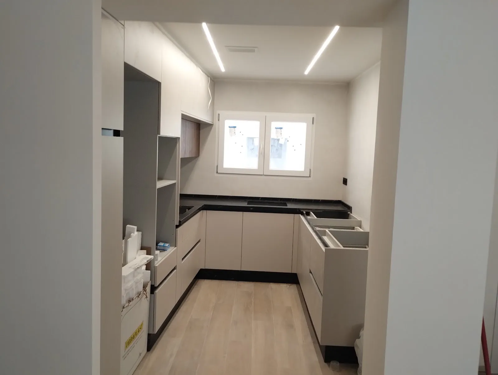 Kitchen with linear LED lights recessed in the ceiling